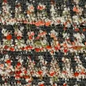 Dark gray woven fabric with muted orange, cream, and pale green floral motifs; visible texture and a complex, layered pattern.